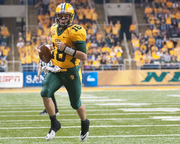 North Dakota State quarterback Brock Jensen scores a first half touchdown against Coastal Carolina during an NCAA college football game in the quarter
