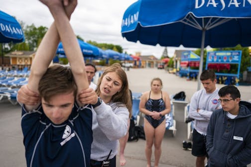 Aimee Ilkka, 19, of New Prague, leads an emergency response training session for lifeguards in the water park area called Breakers Bay at ValleyFair.