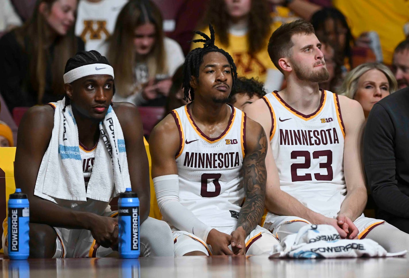 Minnesota Gophers forward Isaiah Ihnen (5), guard Elijah Hawkins (0) and forward Parker Fox (23) are dejected on the bench as their team trails the Iowa Hawkeyes late in the second half Monday, Jan. 15, 2024 at Williams Arena in Minneapolis, Minn..