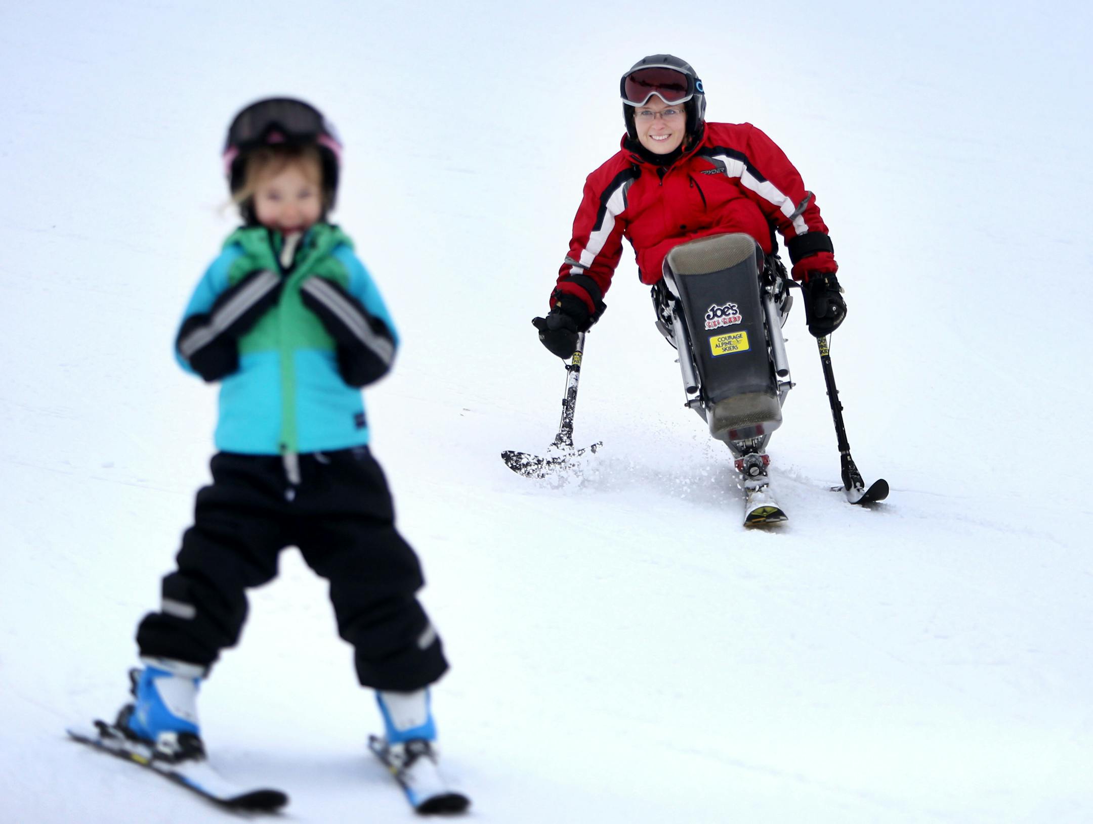 Tracy Tabaka headed down the hill on mono skis as her daughter Taylor, 5, skied ahead of her at Hyland Hills in Bloomington.