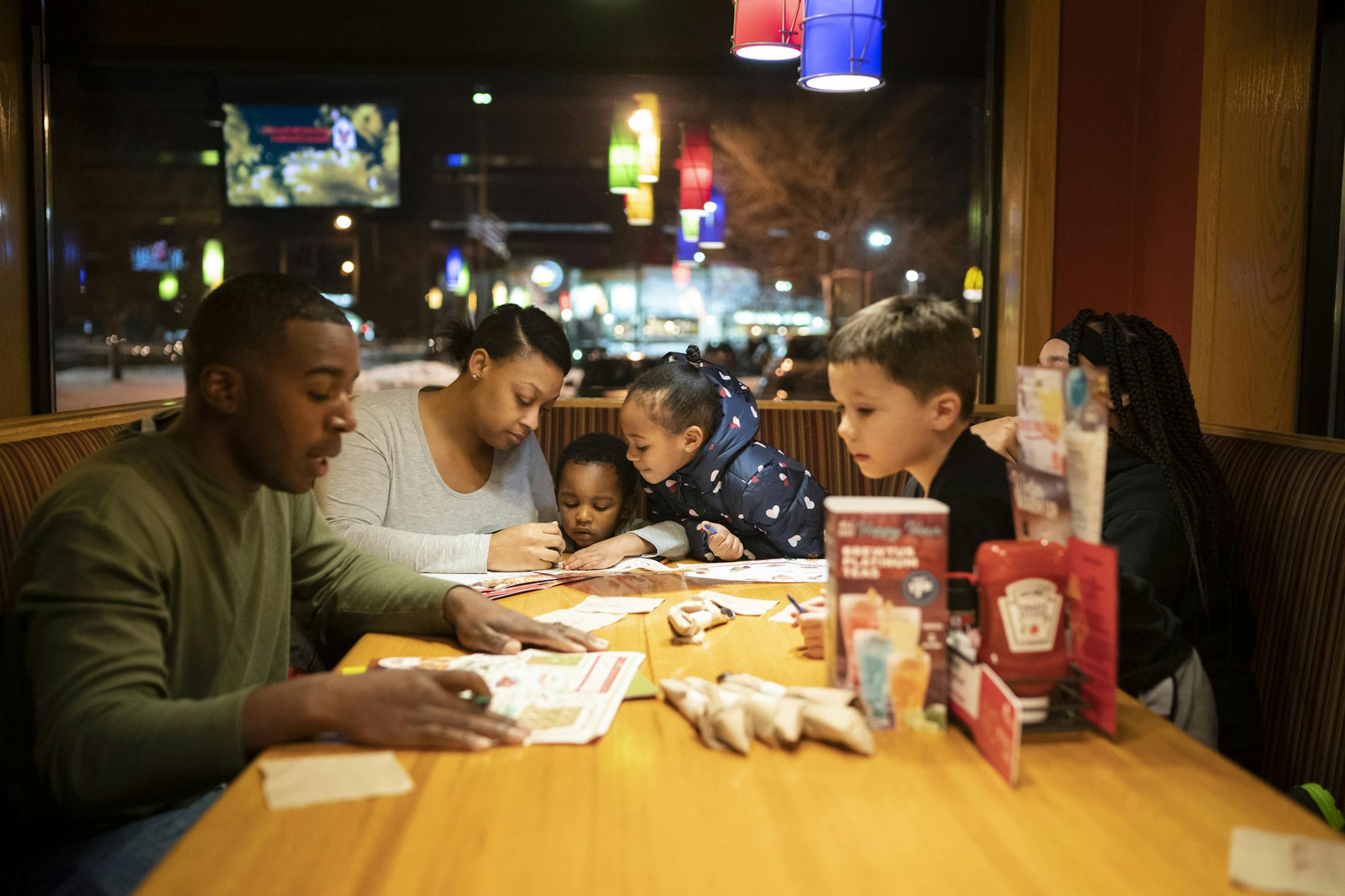 Deonte Haynes and Ja'Mira Haynes kept their little kids busy with activities as they all went out to dinner the night before Deonte had to return back to Fort Hood, Texas the the Army National Guard before he deploys to the Middle East. Photographed on Monday, December 2, 2019. ] RENEE JONES SCHNEIDER &#xa5; renee.jones@startribune.com