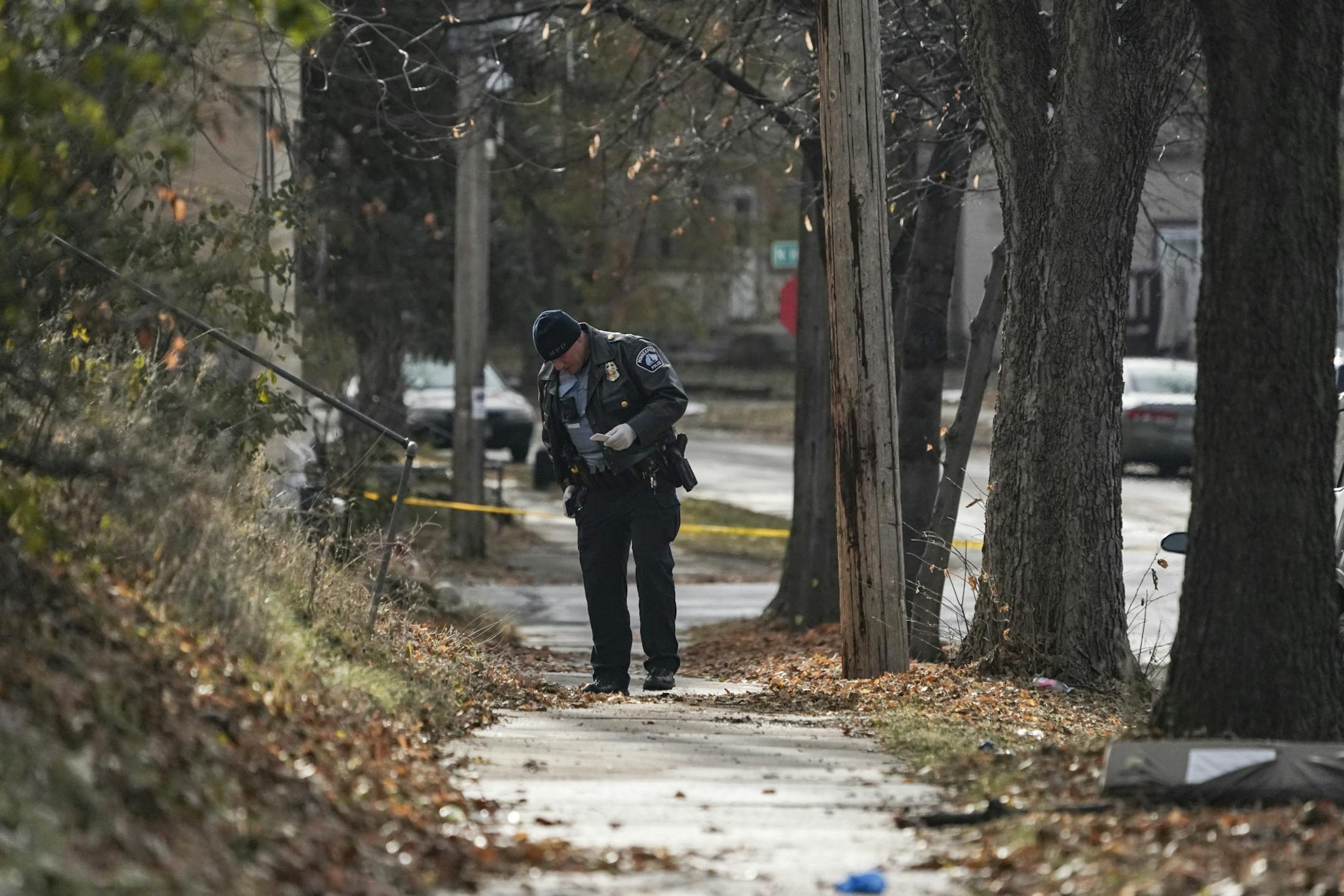 Police investigate the scene of a triple shooting near the corner of North Ilion Avenue and North Hillside Avenue in Minneapolis, Minn., on Friday, November 15, 2019.