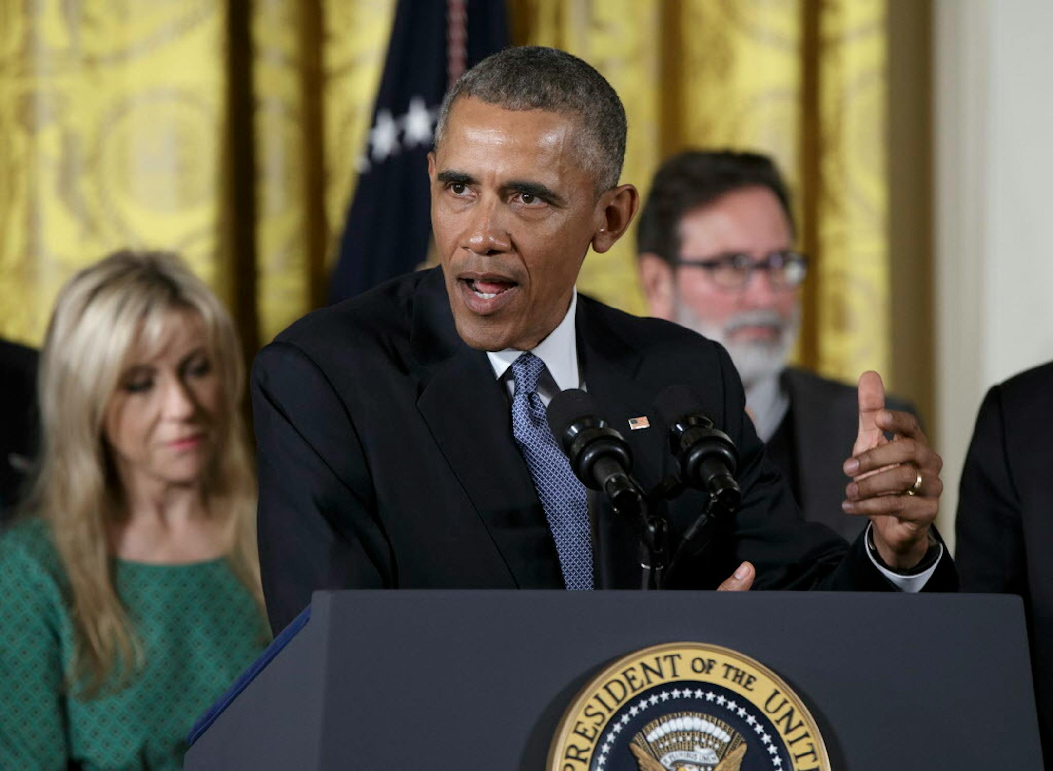 President Barack Obama speaks in the East Room of the White House in Washington, Tuesday, Jan. 5, 2016, about steps his administration is taking to reduce gun violence. Also on stage are stakeholders, and individuals whose lives have been impacted by the gun violence. (AP Photo/Carolyn Kaster)