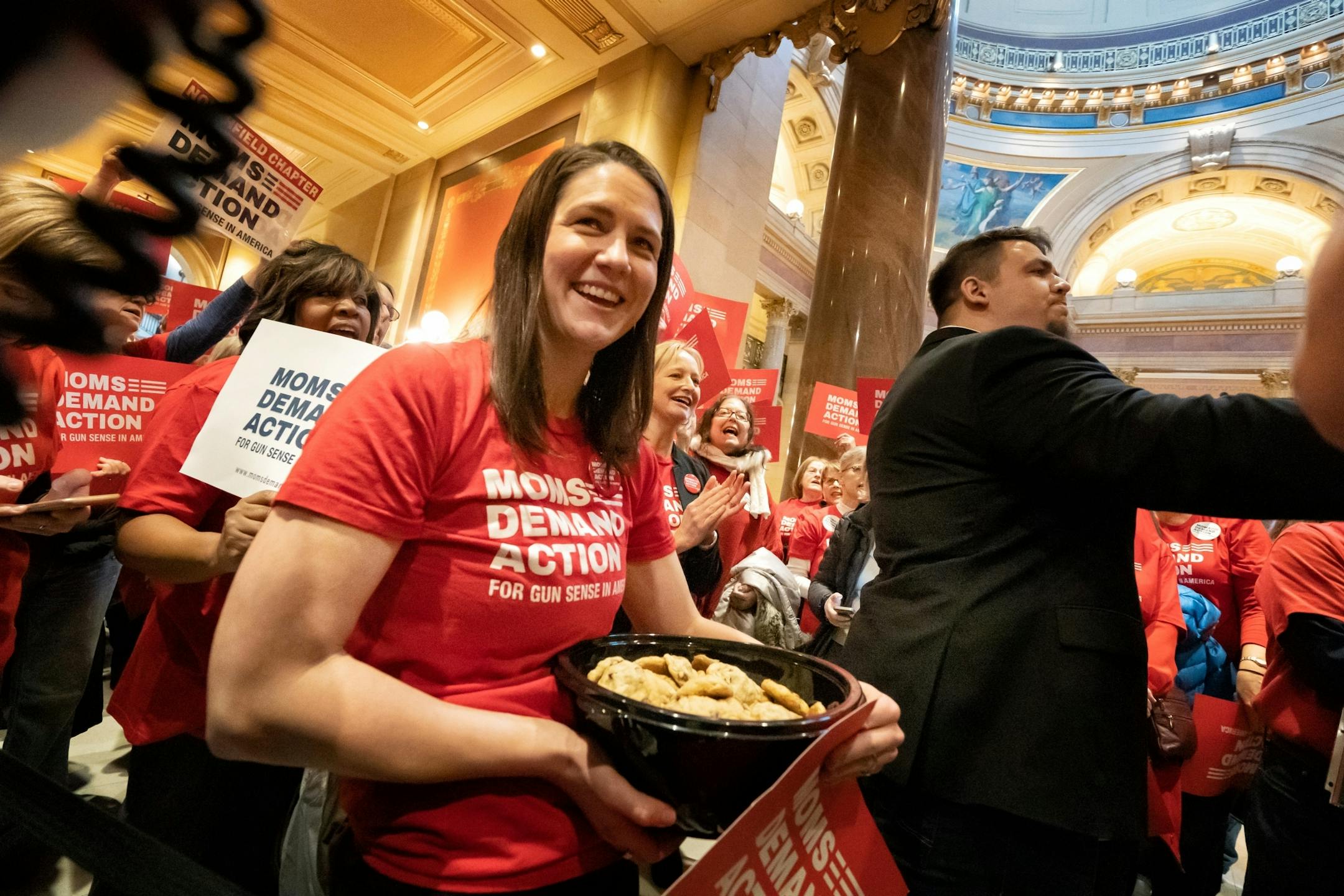 Steph Kennelly of Moms Demand Action for Gun Sense in America, handout out chocolate chip cookies in front of the House Chamber as the group rallied for sensible gun laws.