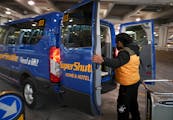 A SuperShuttle van trunk picked up passengers outside Minneapolis-St. Paul International Airport  in 2019.