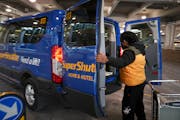 A SuperShuttle van trunk picked up passengers outside Minneapolis-St. Paul International Airport  in 2019.