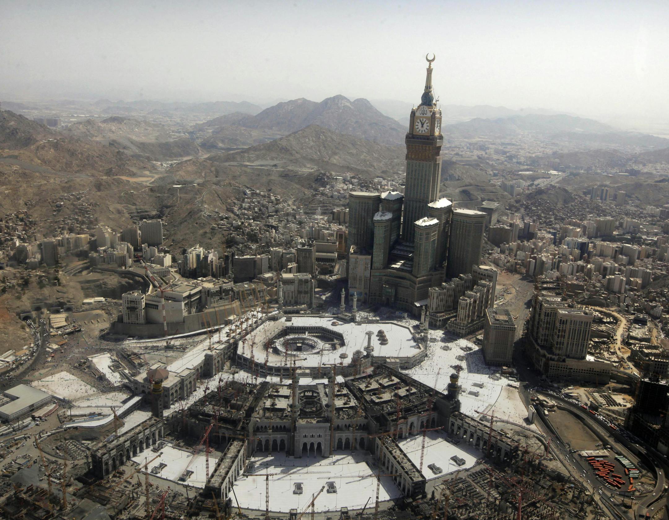 The tallest clock tower in the world with the world's largest clock face at the Abraj Al-Bait Towers overlooks the Grand Mosque and its expansion in Mecca, Saudi Arabia, Wednesday, Oct. 16, 2013. More than 2 million pilgrims _ about 1 million fewer than last year _ perform the hajj, a central pillar of Islam and one that able-bodied Muslims must make once in their lives, is a four-day spiritual cleansing based on centuries of interpretation of the traditions of Prophet Muhammad. (AP Photo/Amr Na