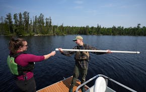 Corinne Garber, monitoring program field manager for Save the Boundary Waters, and Andrew Gardon, a conservation biologist, collect samples to test wa