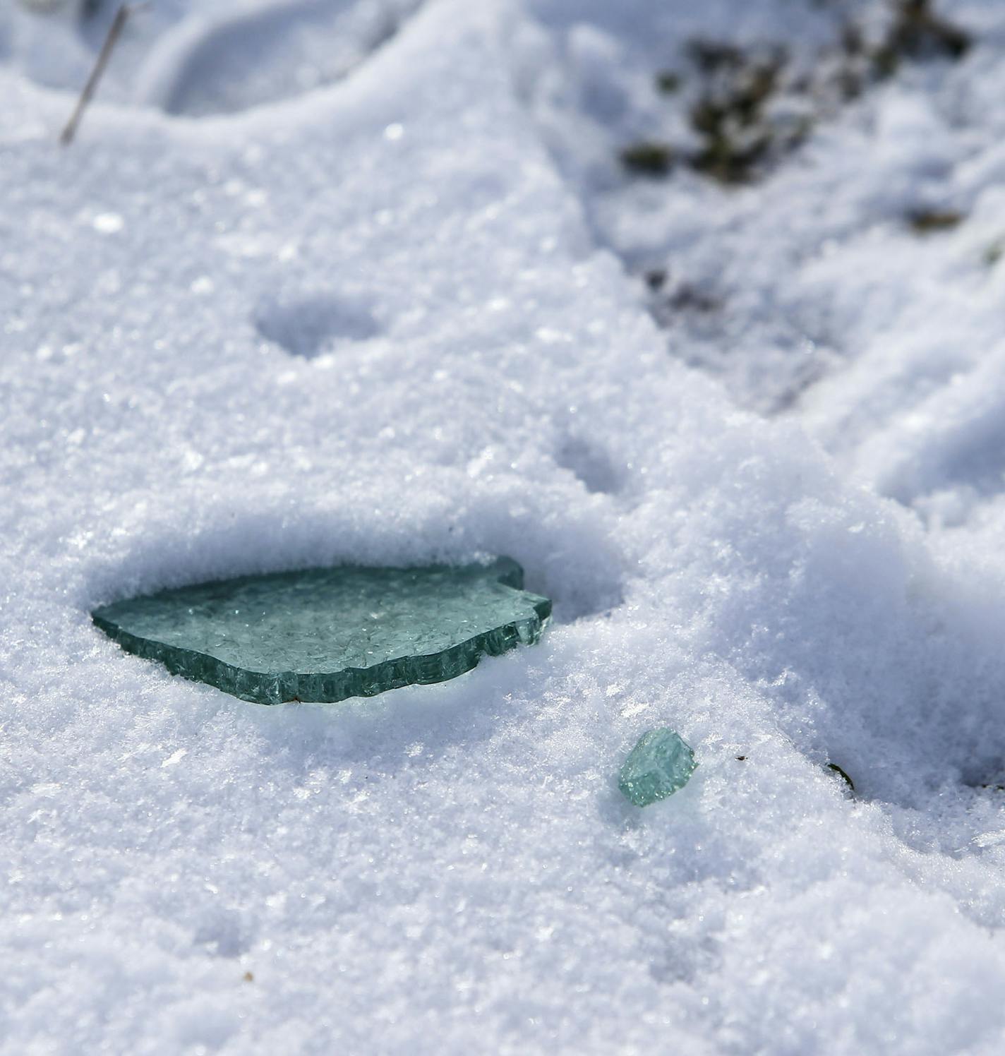 Elm Creek Rest Area, the site of an early morning homicide that took place Wednesday in Maple Grove. Here, a shard of broken glass, near a set of tire tracks that go through the rest area grounds before heading onto the I-94 eastbound ramp. The shooting triggered a high speed chase that concluded with the suspect crashing on I-694 near Rice Street before being shot and killed by law enforcement officers in Shoreview, MN, Wednesday, Dec. 17, 2014.](DAVID JOLES/STARTRIBUNE)djoles@startribune.com T