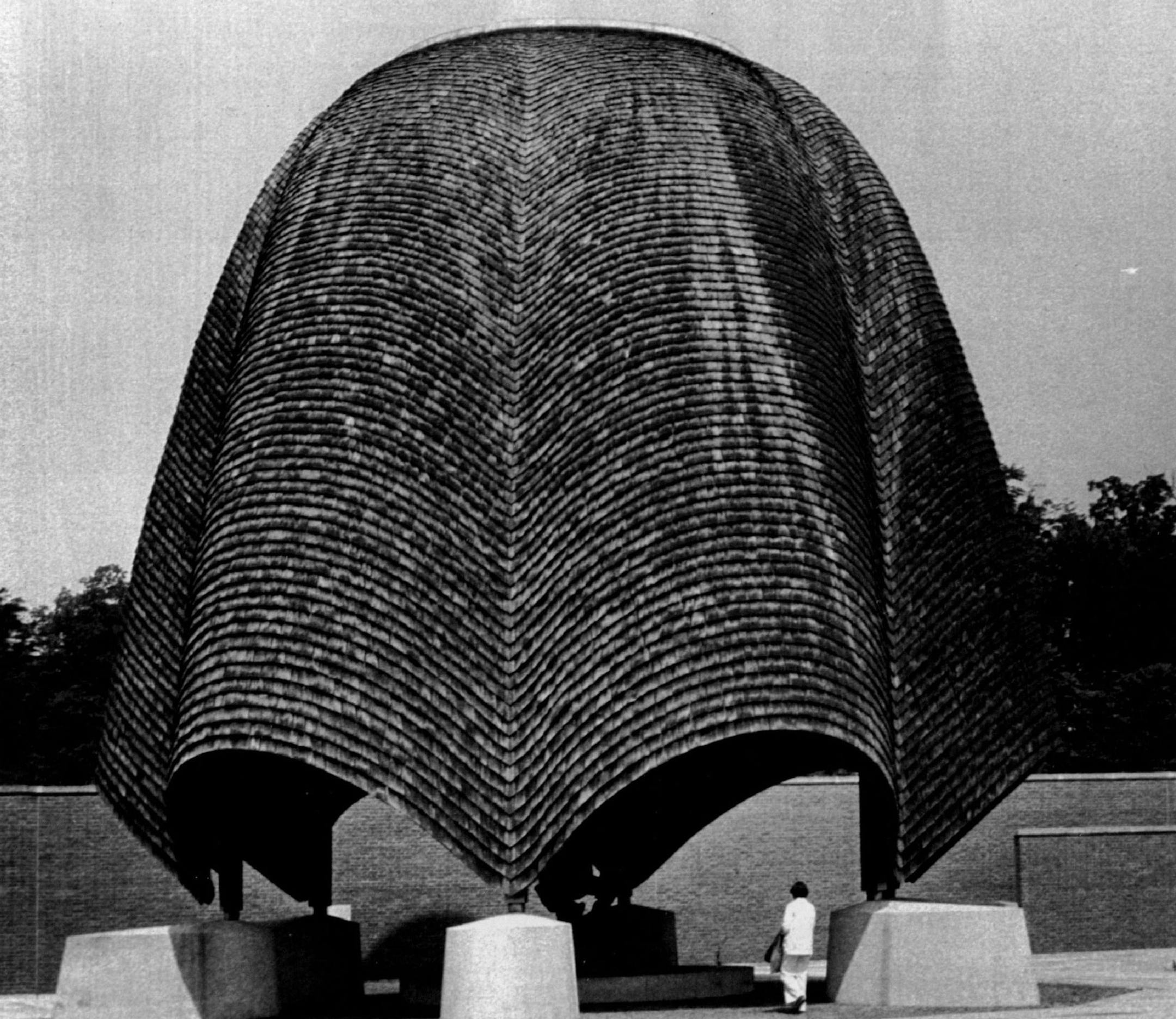 June 21, 1983 a tourists inspects the "roofless church" of historic New Harmony, ind., a town the head of the Indiana geological survey says could be washed away by the Wabash River by the year 2000 unless preventive measure are taken,. The church dome is shaped like an inverted rosebud. Sam Hancock, UPI