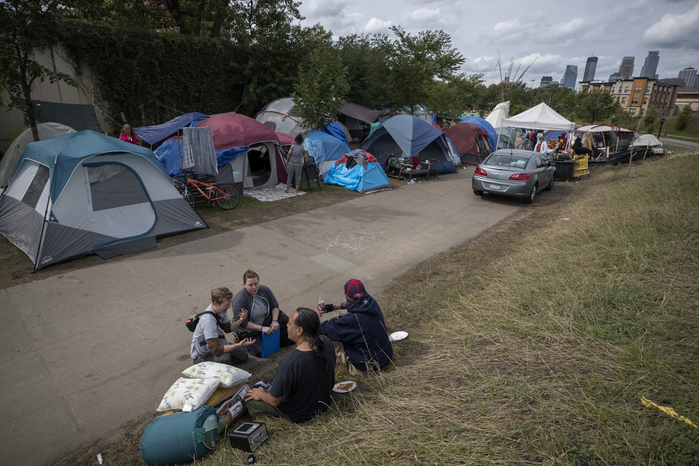 Lewis Simpler left, and Jessie Horan LPN,members of a team of nurses with Livio Health Group took the vital signs of Anthony Nichols 52, at the large homeless camp Monday in Minneapolis.