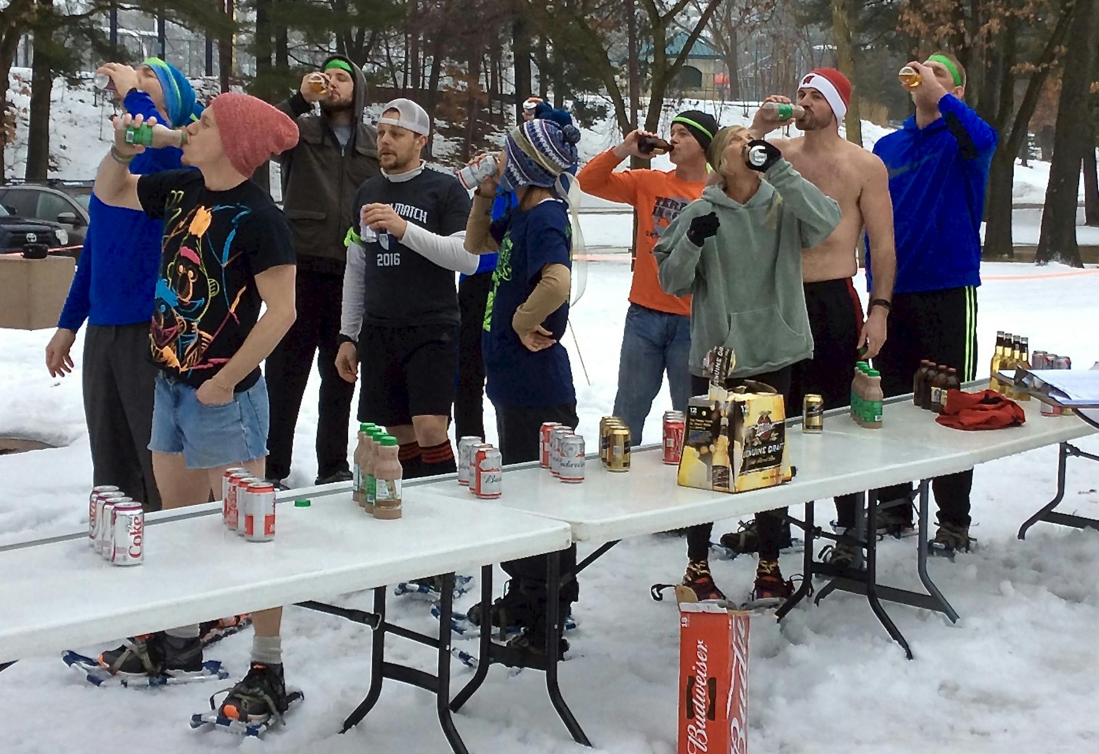 Beer Mile participants, some who took the option for nonalcoholic beverages, stopped before taking on another mile Jan. 21, 2017, in Eau Claire.