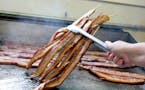 Bacon on-a-stick is cooked all day long at the highly aromatic Big Fat Bacon stand.