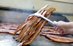 Bacon on-a-stick is cooked all day long at the highly aromatic Big Fat Bacon stand.
