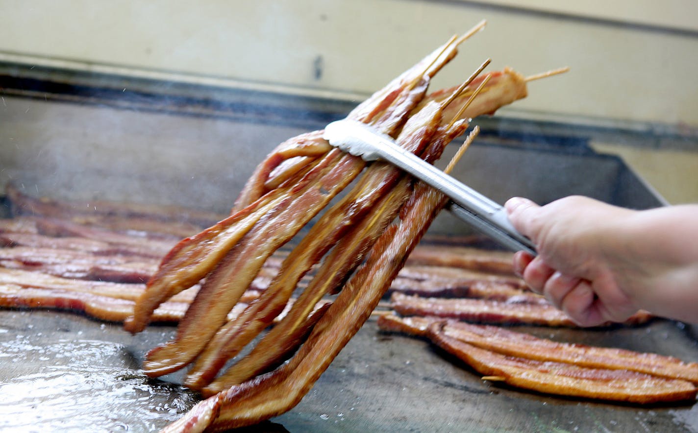 Bacon on-a-stick is cooked all day long at the highly aromatic Big Fat Bacon stand.