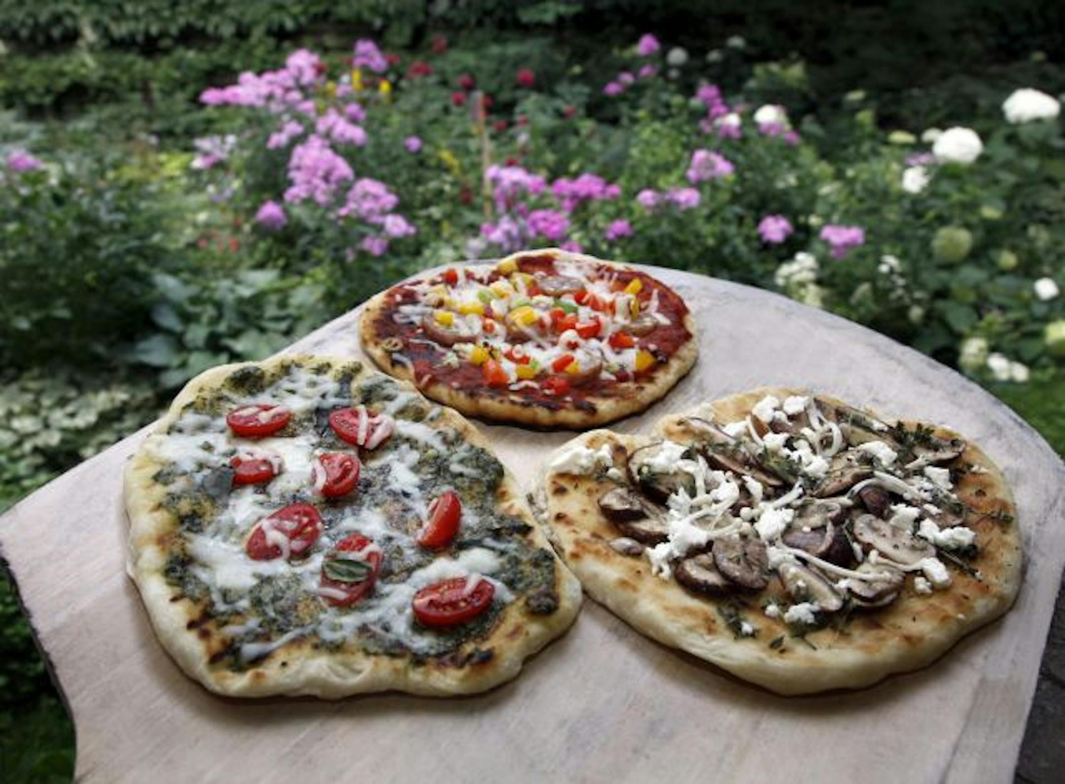 Grilled pizzas are perfect for summer dining. Choose from a variety of fresh, seasonal toppings and keep the house cool in the process.