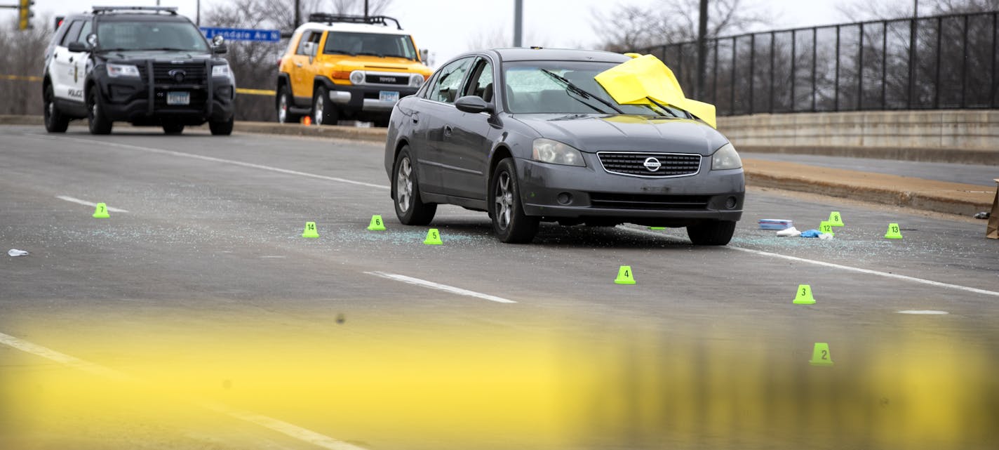 Members of the crime lab collected evidence from around the car where one man was shot to death and another wounded on 7th St. N heading into downtown Sunday March 31, 2019 in Minneapolis, MN.] Jerry Holt • Jerry.holt@startribune.com