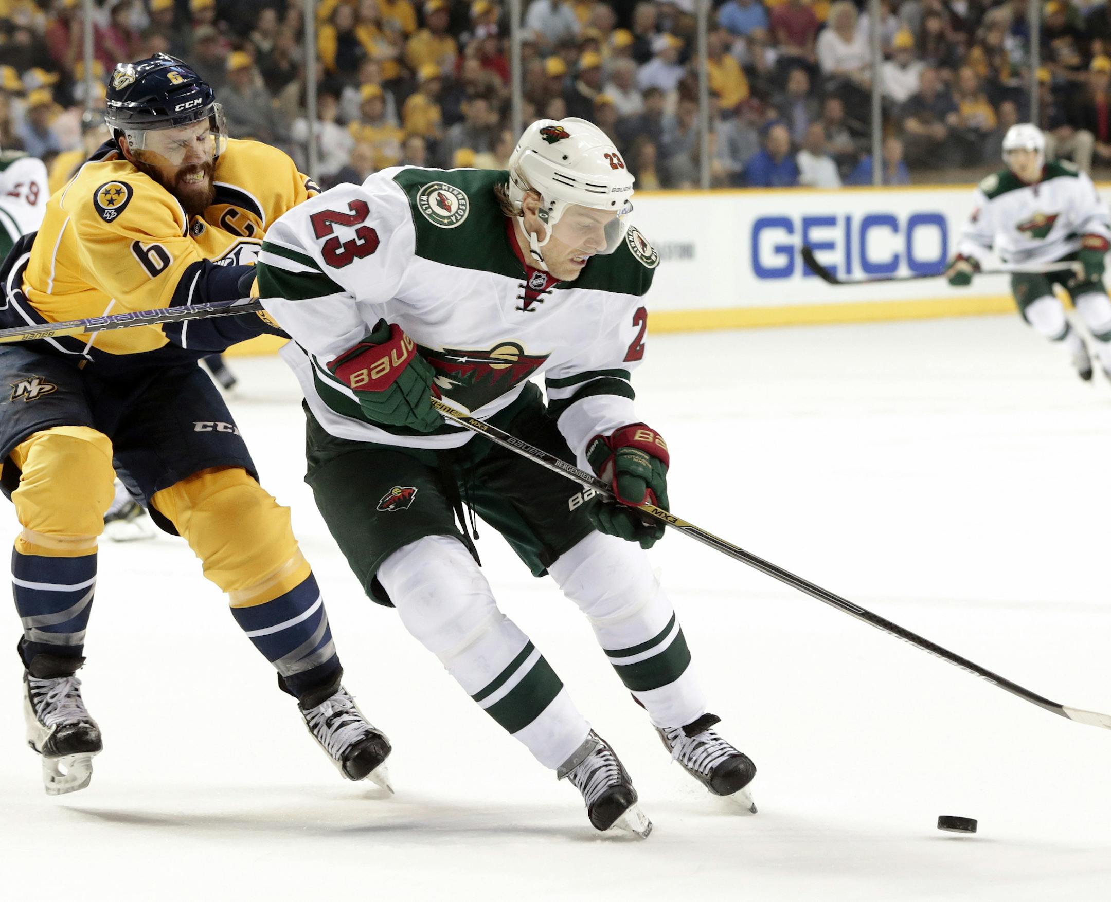 Minnesota Wild left wing Sean Bergenheim (23), of Finland, is defended by Nashville Predators' Shea Weber (6) in the second period of an NHL hockey game Thursday, April 9, 2015, in Nashville, Tenn. (AP Photo/Mark Humphrey)