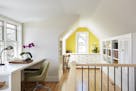 More windows, a skylight and built-in desks, bookshelves and file cabinets, provide lots of natural light and work layout space in the converted third