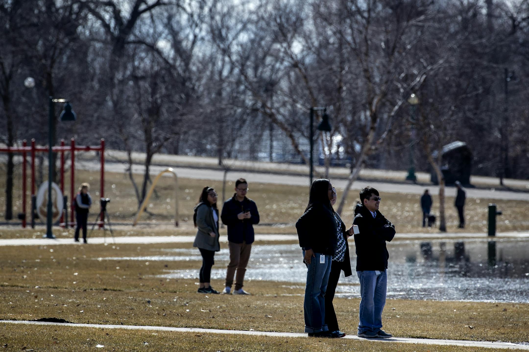 Pedestrians came out to view the flooding at Harriet Island Regional Park and the flowing Mississippi river on Monday afternoon.