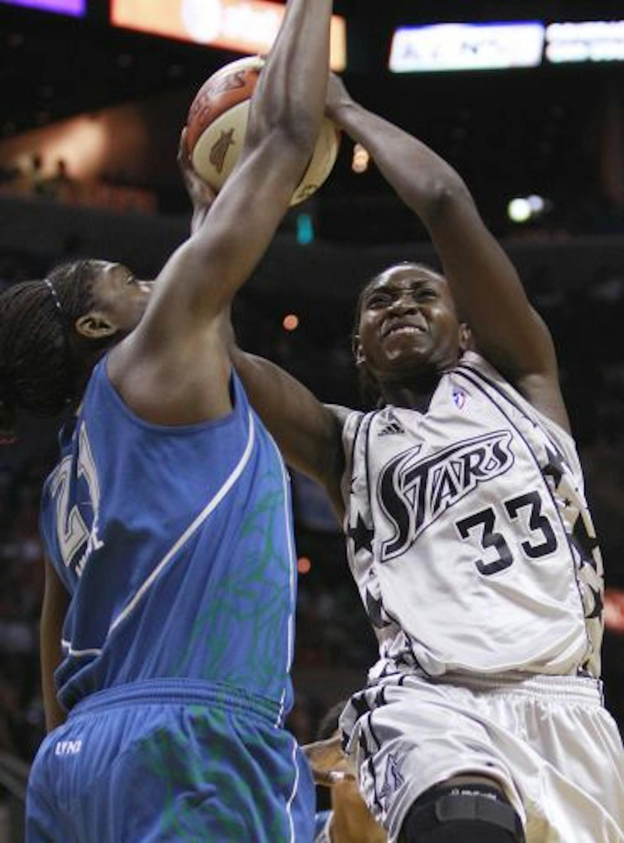San Antonio Silver Star's Sophia Young (33) is fouled as she drives to the basket by Minnesota Lynx's Nicky Anosike, left, during the first quarter of a WNBA basketball game, Saturday, June 26, 2010 in San Antonio.