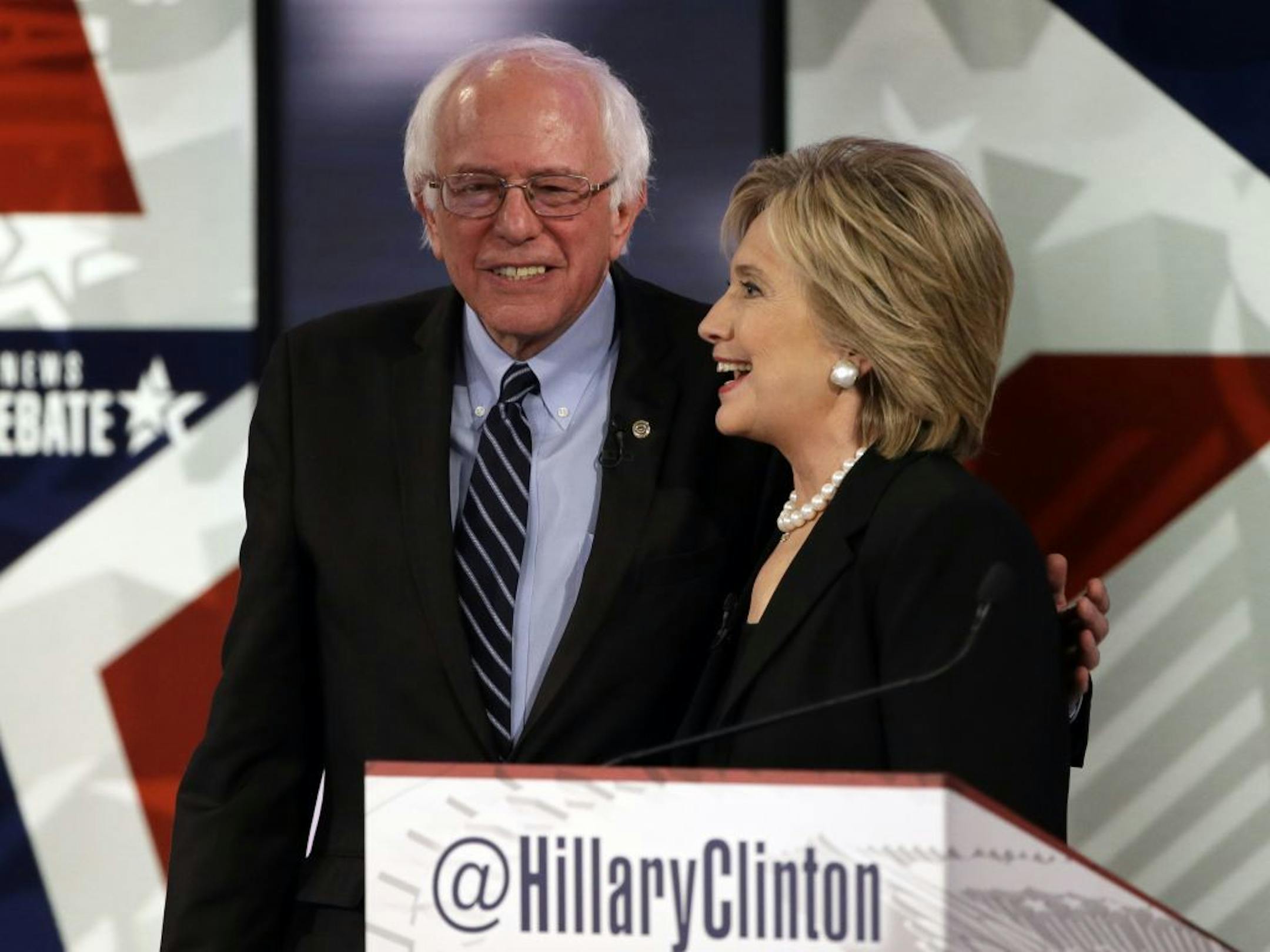 Hillary Rodham Clinton, right, talks to Bernie Sanders after a Democratic presidential primary debate, Saturday, Nov. 14, 2015, in Des Moines, Iowa.