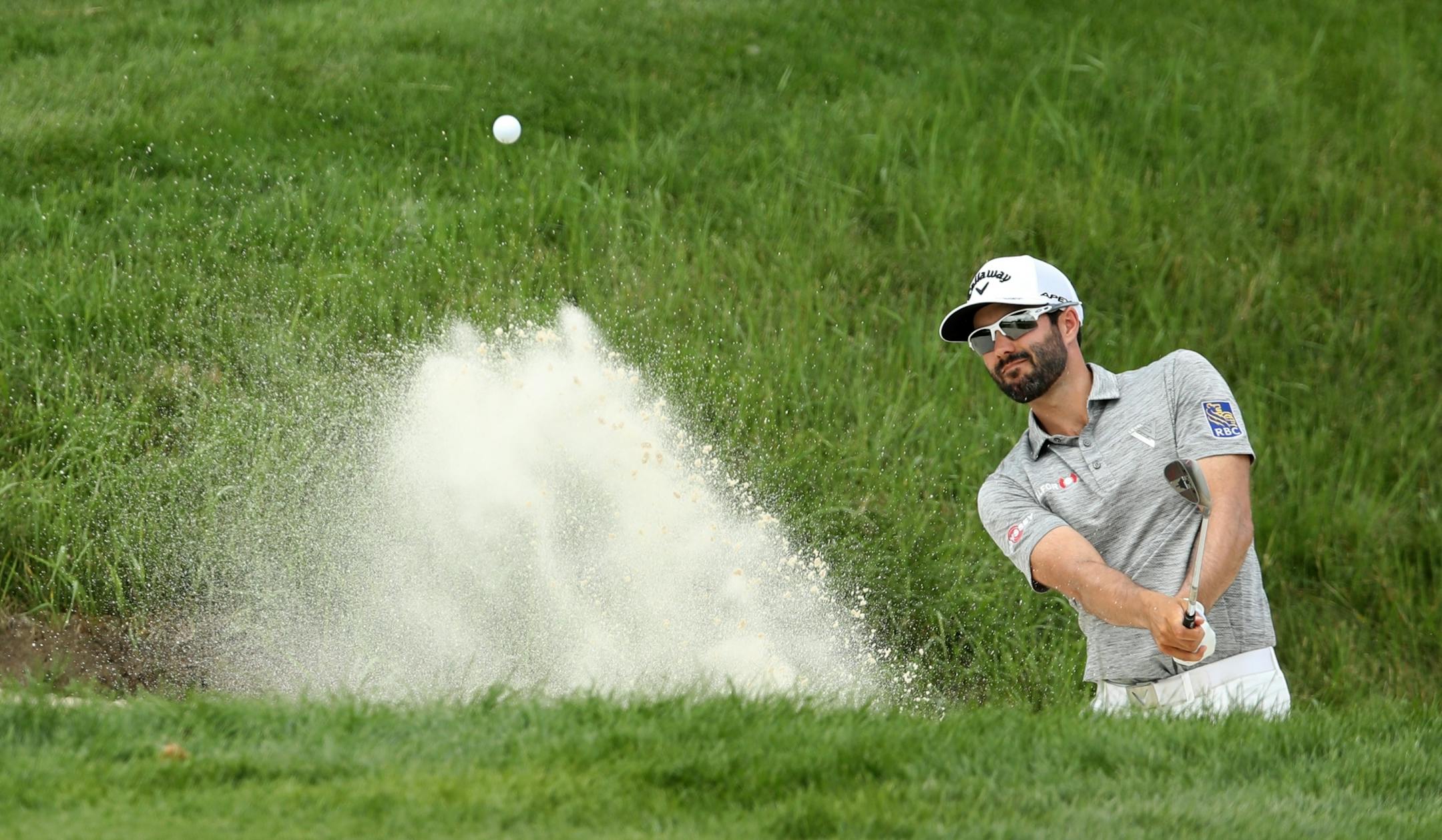 Charles Howell III hits out of the bunker at the second hole during the final day of the 3M Open at TPC Twin Cities.