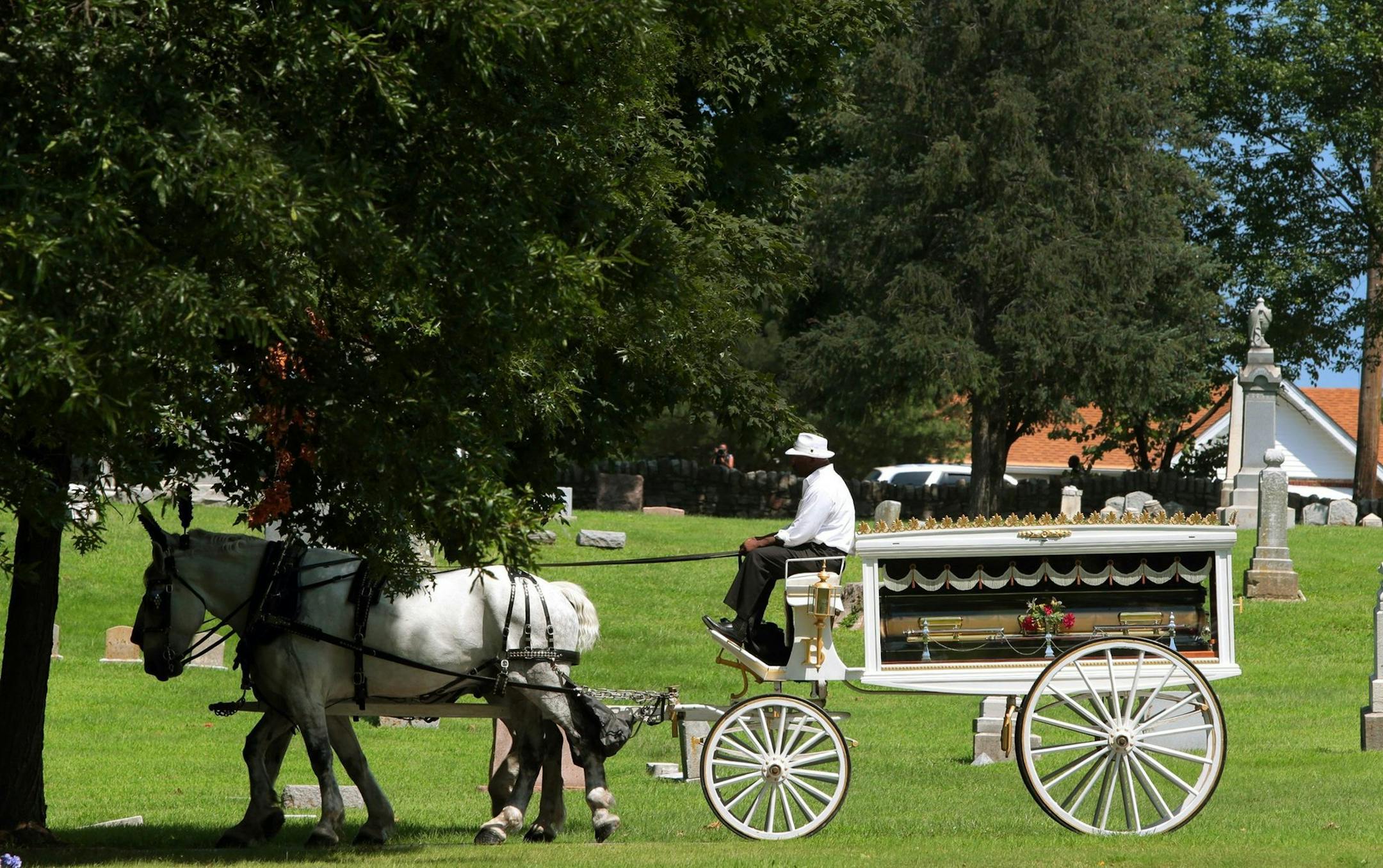 The casket of Michael Brown is carried by wagon into St. Peter's Cemetery to his gravesite in Normandy, Mo. on Monday, Aug. 25, 2014. (Robert Cohen/St. Louis Post-Dispatch/MCT) ORG XMIT: 1156525