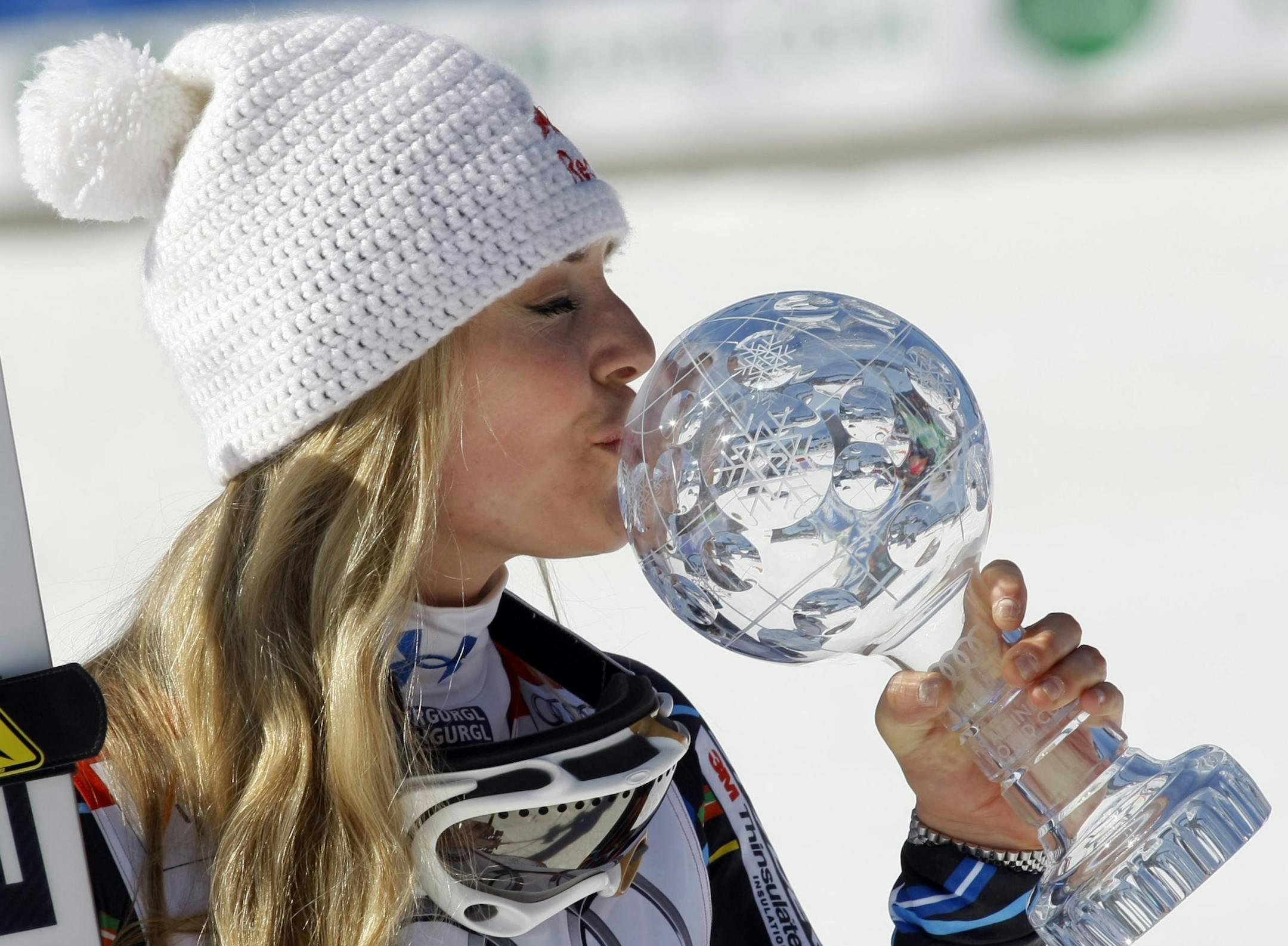 Lindsey Vonn, of the United States, kisses the trophy of the alpine ski, women's World Cup downhill discipline title, in Schladming, Austria, Wednesday, March 14, 2012.