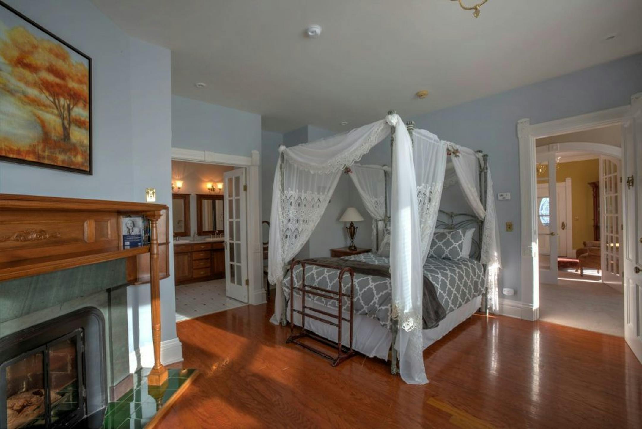A bedroom with a fireplace.