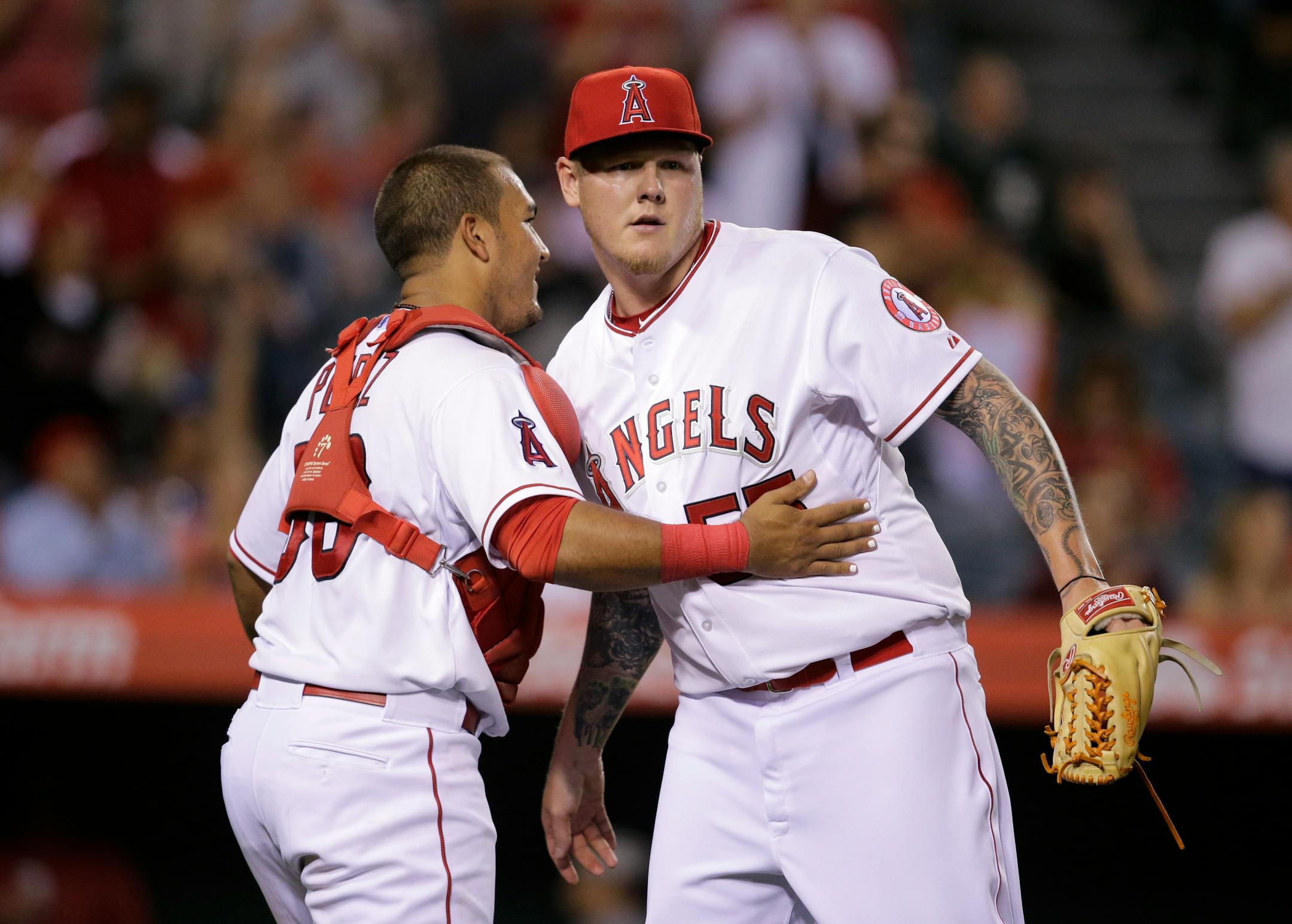 Los Angeles Angels relief pitcher Mat Latos, right, and catcher Carlos Perez celebrated their team's 8-1 win against the Oakland Athletics on Tuesday.