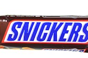 Kwidzyn, Poland &#x2013; February 27, 2014: Snickers chocolate bar isolated on white background. Snickers bars are produced by Mars Incorporated. Snic