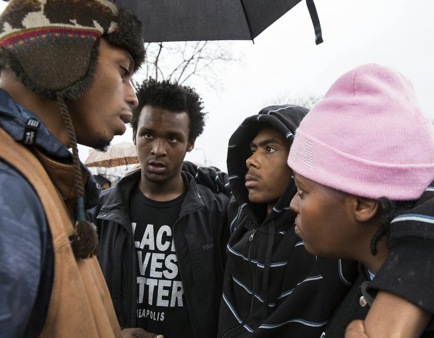 Cameron Clark, from left, one of the five shooting victims from outside the Fourth Precinct and cousin of Jamar Clark, speaks with fellow shooting victims Wesley Martin and Teven King, who is accompanied by his stepmother Timika Merrida, during a press conference outside the Fourth Precinct police station in Minneapolis on Tuesday, December 8, 2015. ] (Leila Navidi/Star Tribune) leila.navidi@startribune.com BACKGROUND INFORMATION: The NAACP held a press conference outside the Fourth Precinct dem