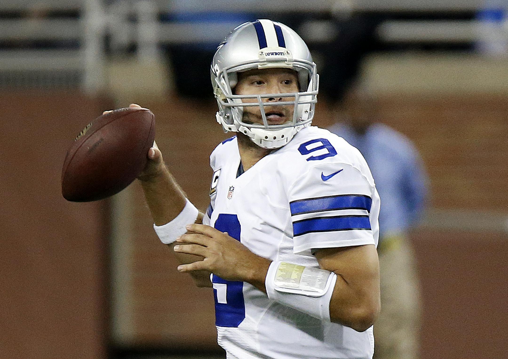 Dallas Cowboys quarterback Tony Romo (9) throws against the Detroit Lions in the first half of an NFL football game in Detroit, Sunday, Oct. 27, 2013. (AP Photo/Duane Burleson) ORG XMIT: MIN2013110118341869