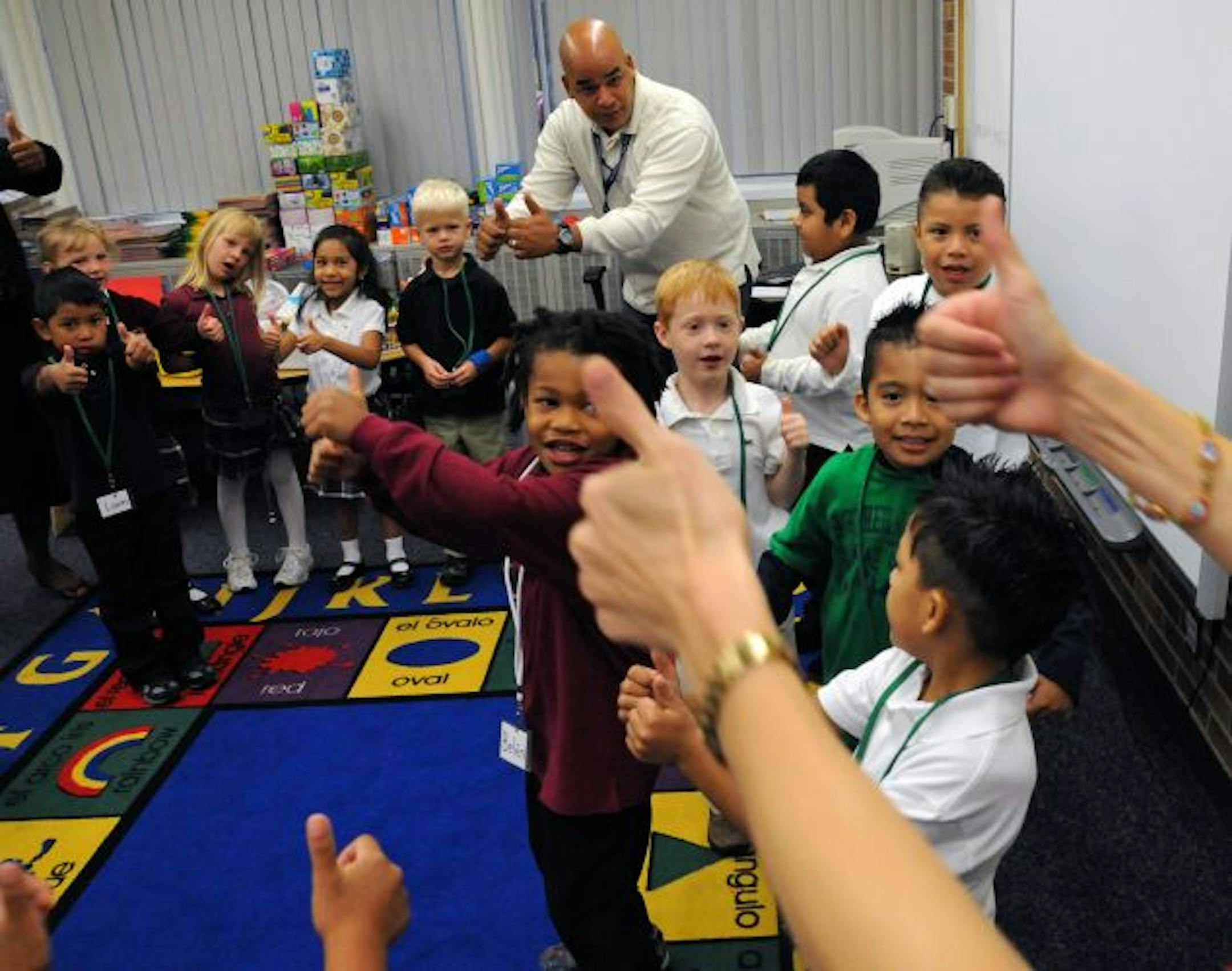 Richfield, Mn Tuesday 9/7/10 First Day of School at the Richfield Dual Language School was charged with language spoken and in gesture. The school features spanish immersion and ASL American Sign Language. Kindergarden teacher Amy Ponce signs with her students the sign of silent applause during the 1st hour of class.