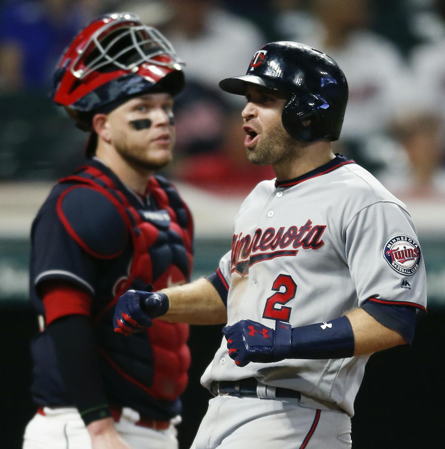 Minnesota Twins' Brian Dozier (2) celebrates after hitting a three run home run off Cleveland Indians relief pitcher Bryan Shaw as catcher Roberto Perez looks on during the eighth inning in a baseball game, Tuesday, Sept. 26, 2017, in Cleveland. (AP Photo/Ron Schwane)