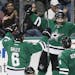 Dallas Stars forward Erik Cole, center, is congratulated by defensemen Trevor Daley (6) and Jason Demers (4) after scoring a goal in the first period 