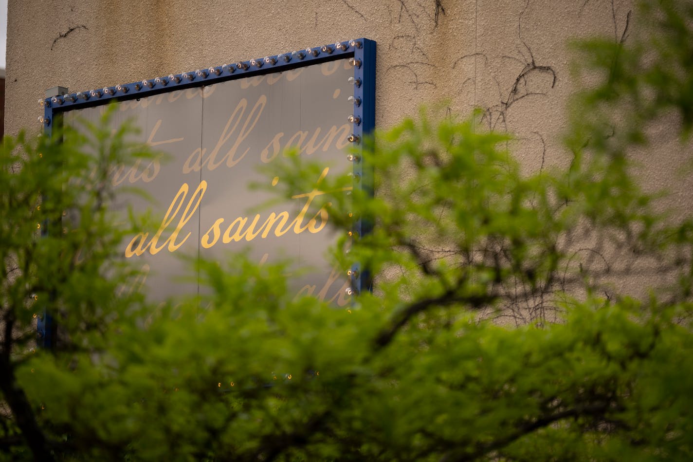 Signage for the restaurant All Saints, above the patio in their Northeast Minneapolis location.