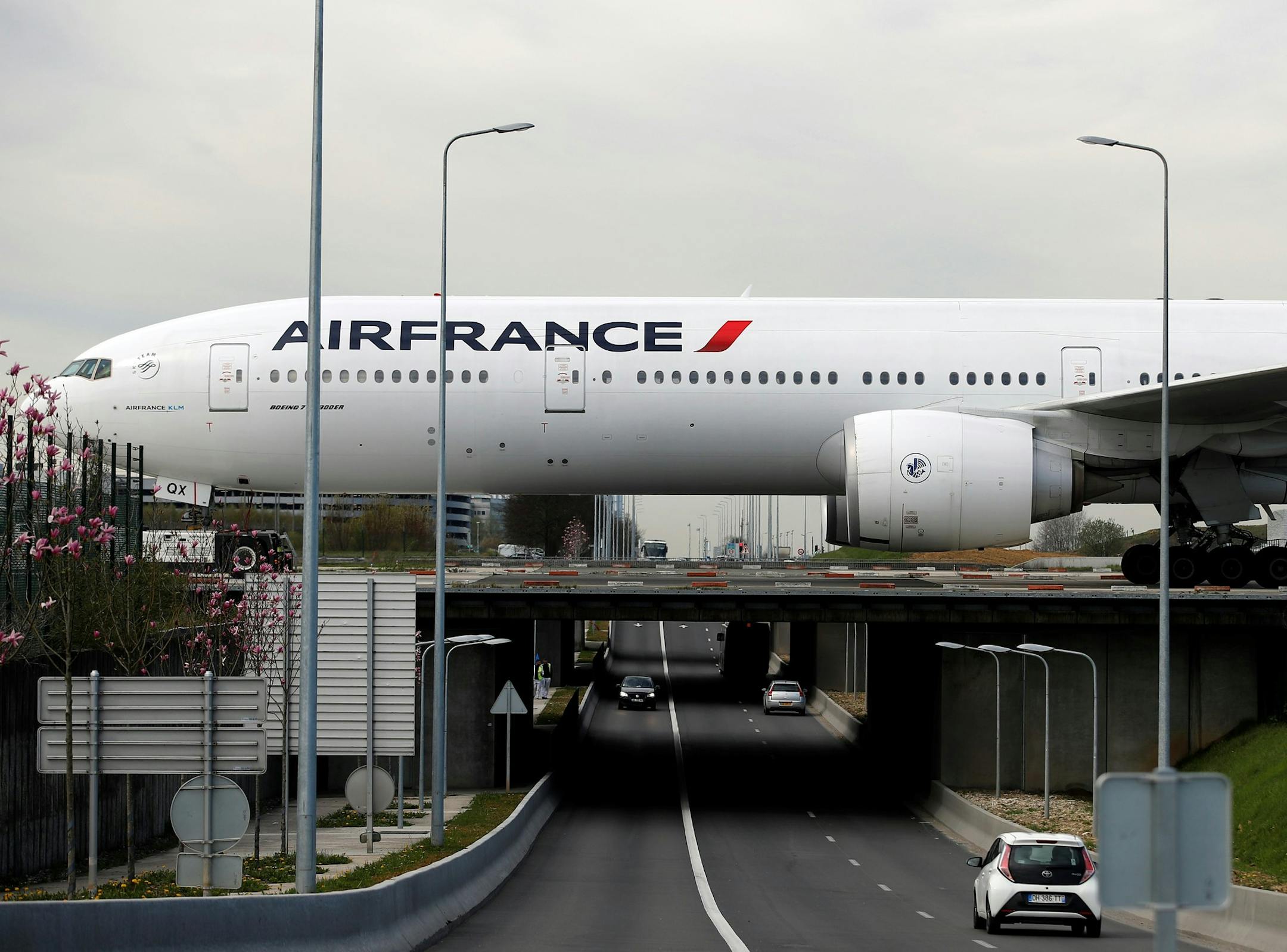 An Air France plane crosses a bridge as he prepares to take off at Paris Charles de Gaulle airport, in Roissy, near Paris, Wednesday, April 11, 2018. About 30 percent of Air France flights scheduled on Wednesday are expected to be canceled as flight crews and ground staff started a seventh day of strike. (AP Photo/Christophe Ena) ORG XMIT: ENA113