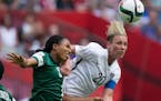 Nigeria's Onome Ebi, left, and United States' Abby Wambach vie for the ball during the second half of a FIFA Women's World Cup soccer game Tuesday, Ju