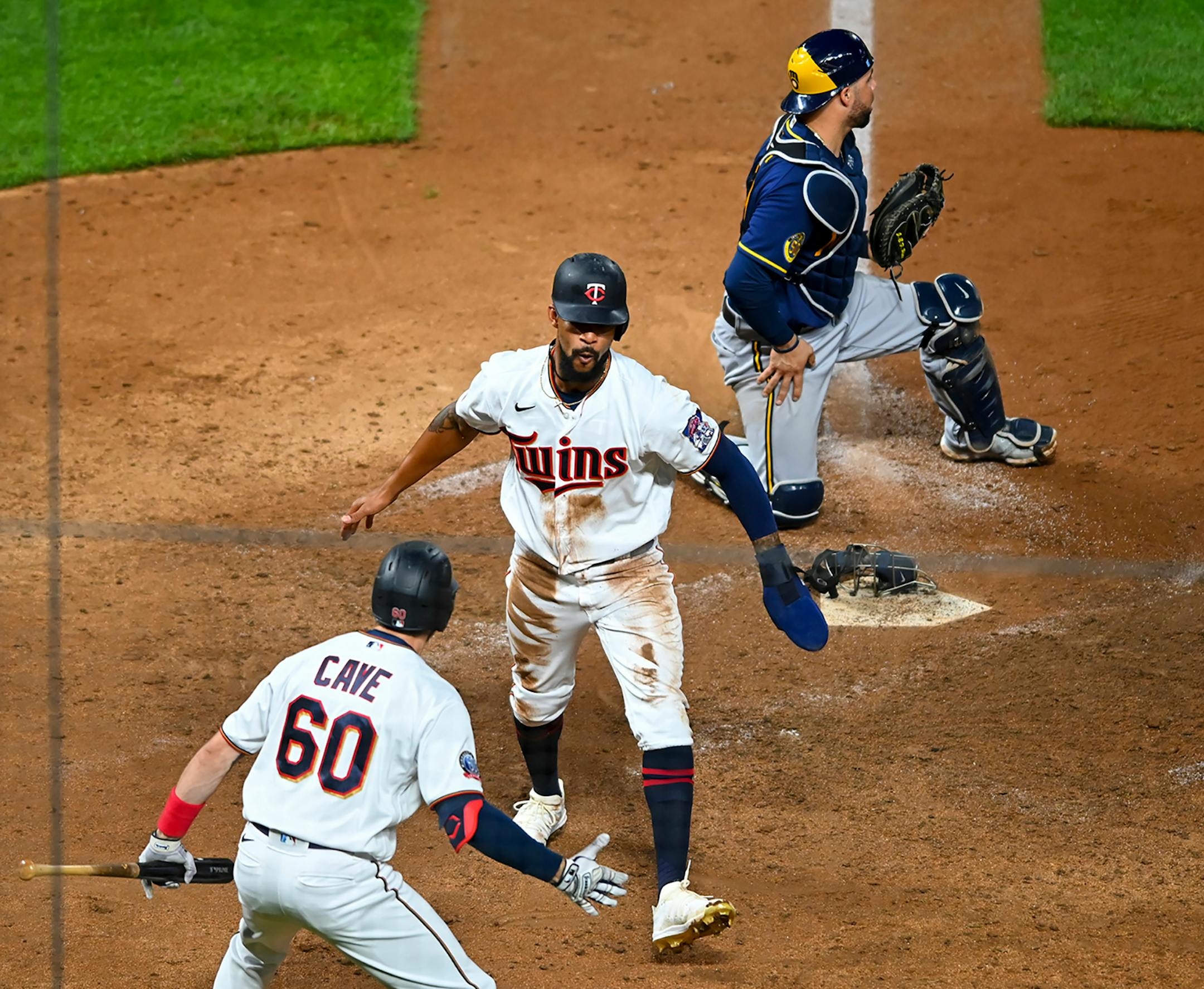Minnesota Twins center fielder Byron Buxton (25) and right fielder Jake Cave (60) celebrated Buxton's game winning walk-off run in the bottom of the 12th inning.