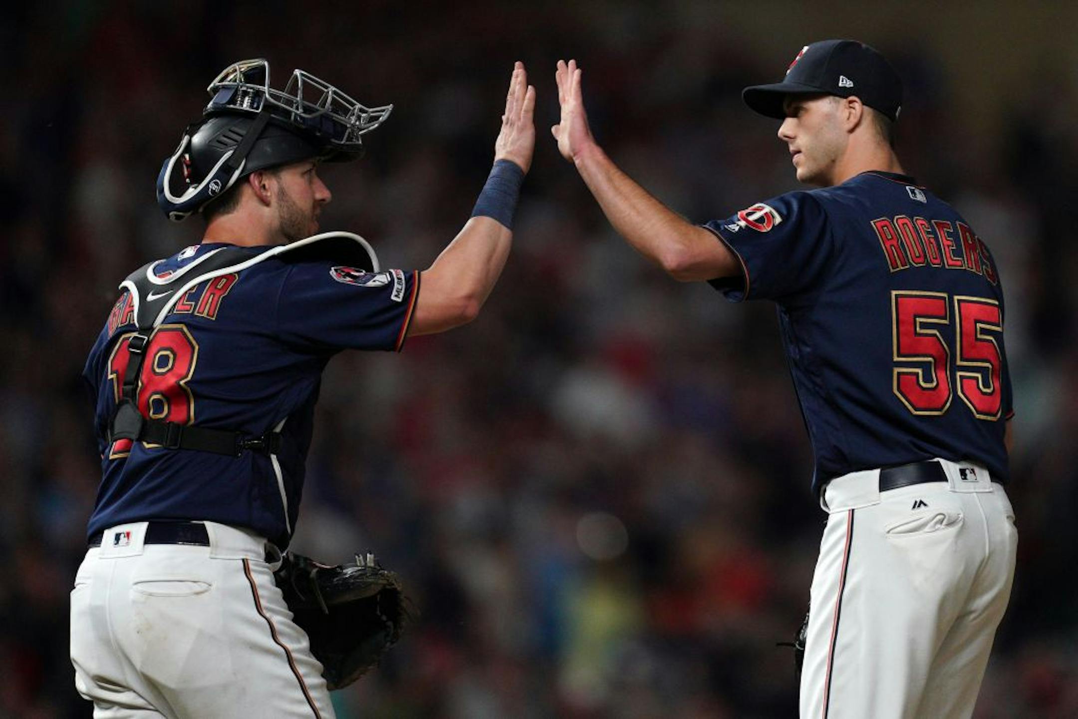 Minnesota Twins catcher Mitch Garver (18) celebrated the win with relief pitcher Taylor Rogers (55).