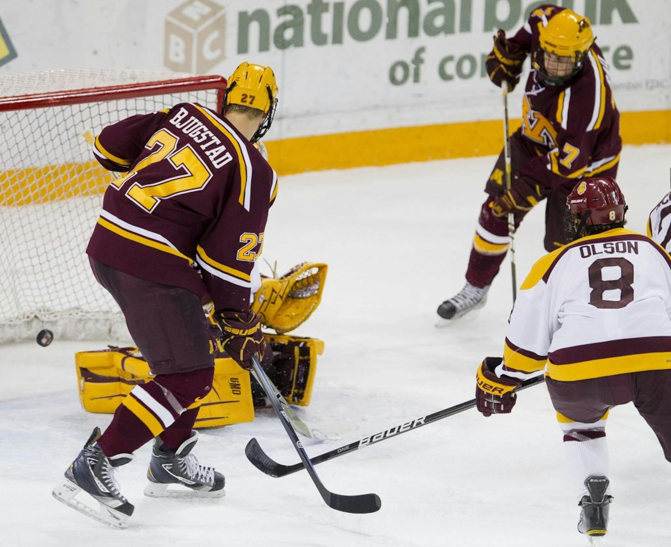 Minnesota's Kyle Rau, top right, scored against Minnesota Duluth. Also pictured is Gopher Nick Bjugstad, left.