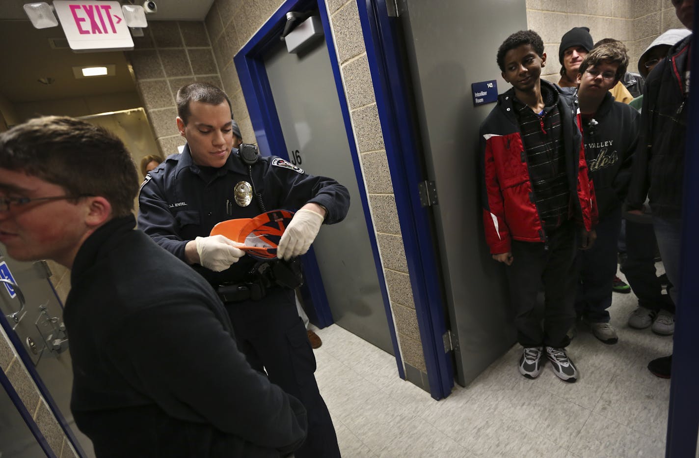 Officer David Engel demonstrated how to search someone on student Jon Epperson, 15, at left, during a Teen Police Academy tour of where people are booked at the Apple Valley Police Department on Tuesday, March 19, 2013, in Apple Valley, Minn. The Apple Valley Police Department holds a Teen Police Academy each Jan. through March for about 20 teens who are interested in law enforcement. ] (RENEE JONES SCHNEIDER * reneejones@startribune.com) Jon epperson CQ