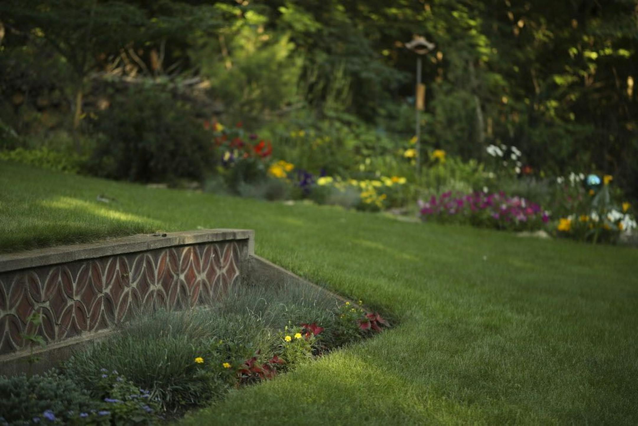 A garden wall created from tiles cast by Gene Waldowski.