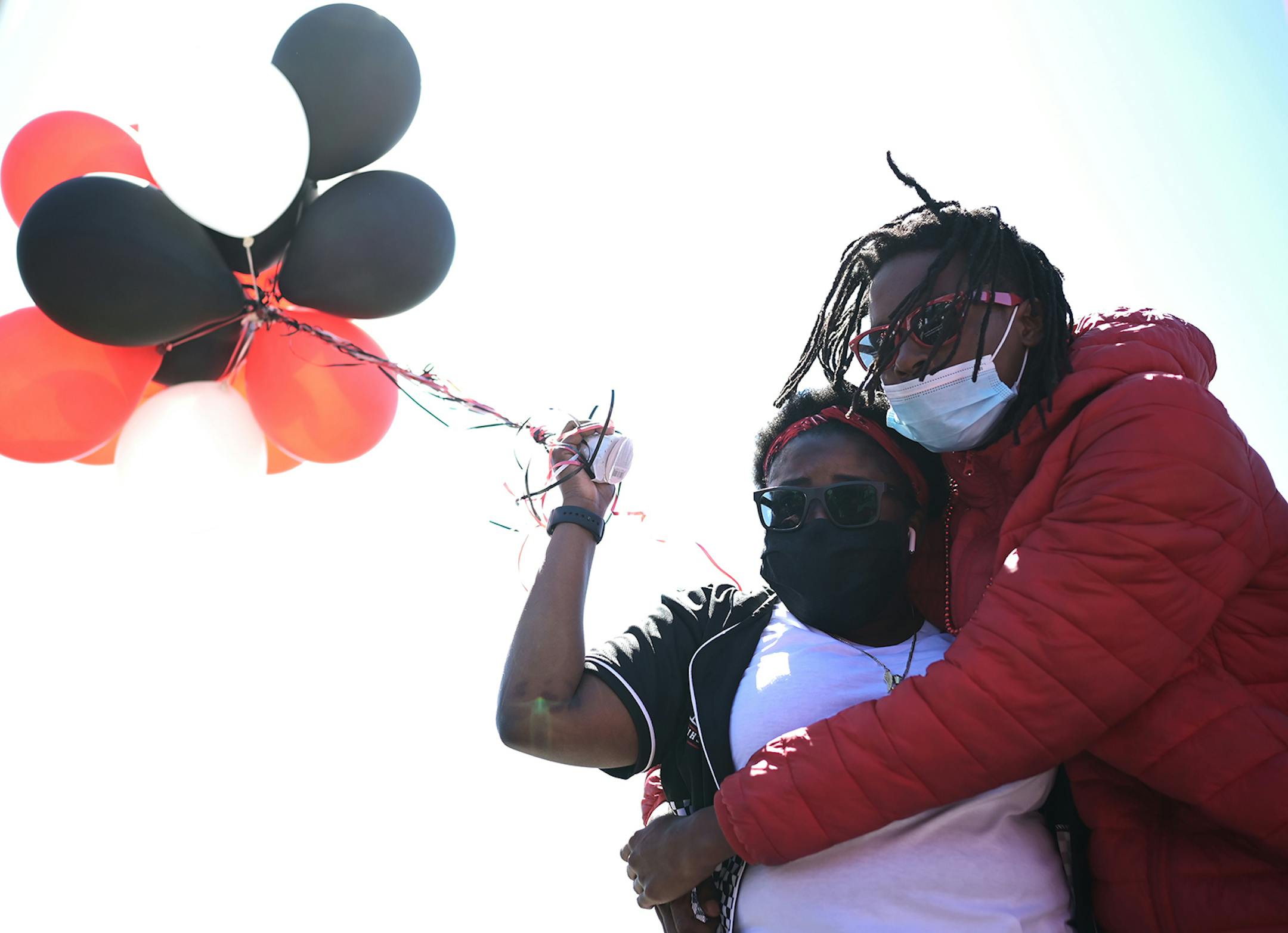 Brittany Lee, niece of Douglas Lewis, was embraced by Lewis' stepson, Michael Tidwell, at a memorial for Lewis Sunday afternoon. A memorial was held for Lewis, who was shot and killed Friday night, on Sunday, May 3, 2020 at the Burns Avenue Scenic Overlook in St. Paul, Minn.