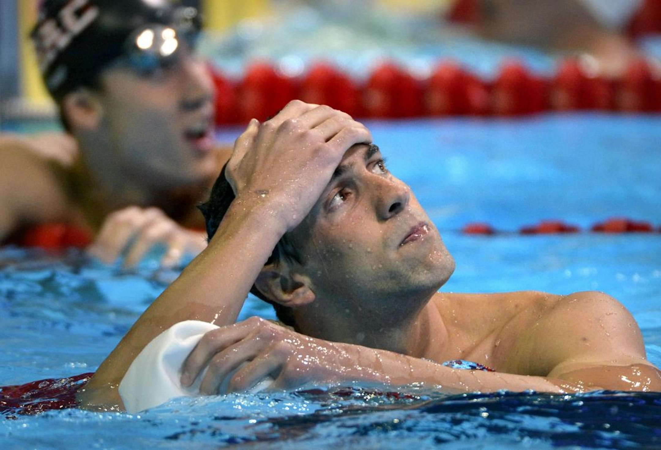 1st Day of competition - U.S. Olympic swimming trials. (IN THIS PHOTO) Swimming superstar Michael Phelps looks up at the clock after his preliminary swim in the Men's 400 Individual Medley. Phelps finnished 2nd with a time of 4:14.72 behind Ryan Lochte who had a time of 4:10.66. Phelps and Lochte will go head to head in the finals tonight.