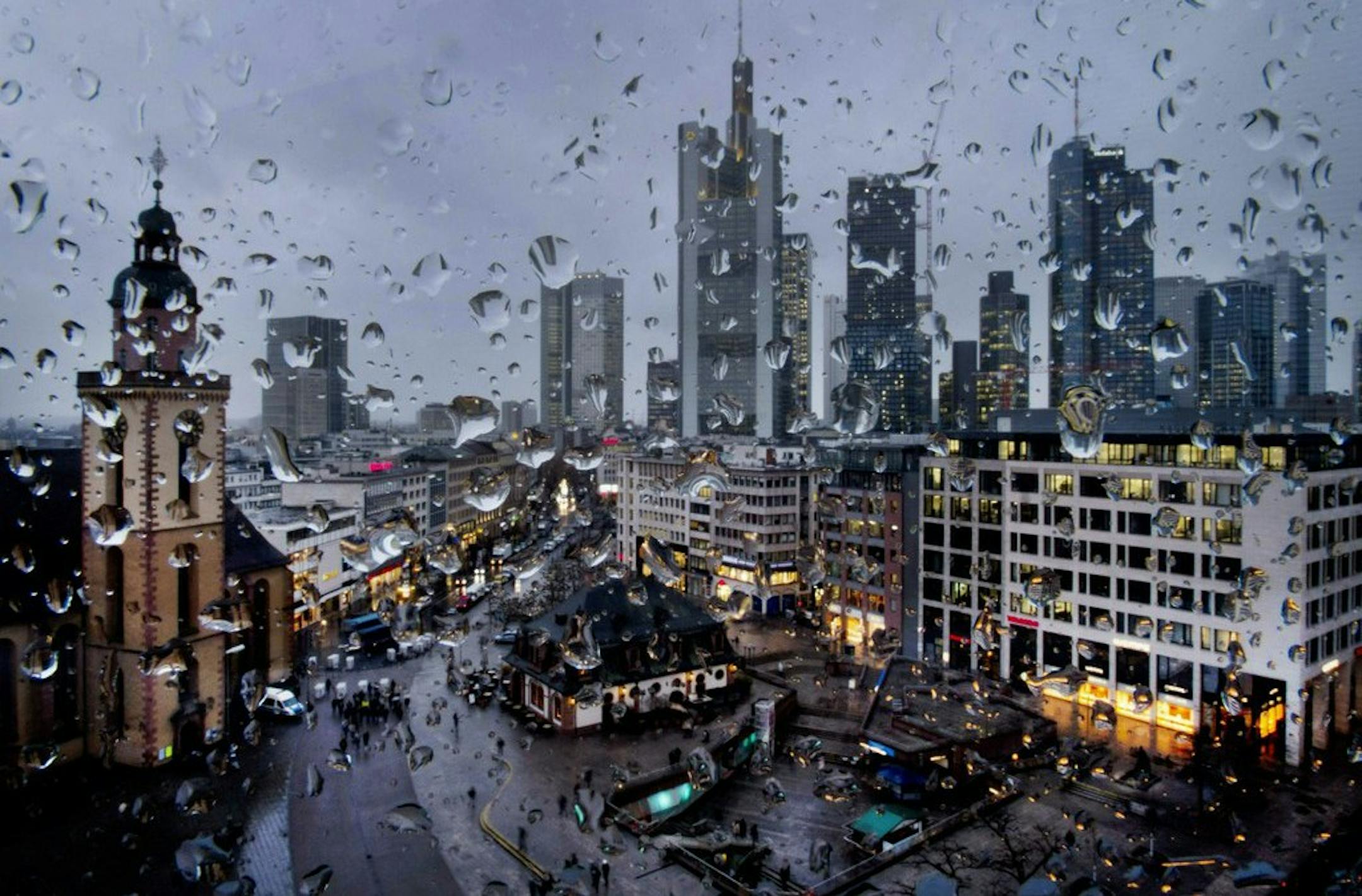 In this Wednesday, Jan. 30, 2019, file photo, the buildings of the banking district are seen behind rain drops on a window in Frankfurt, Germany. Germany's economic growth has stagnated in the last three months of the year. (AP Photo/Michael Probst, file)