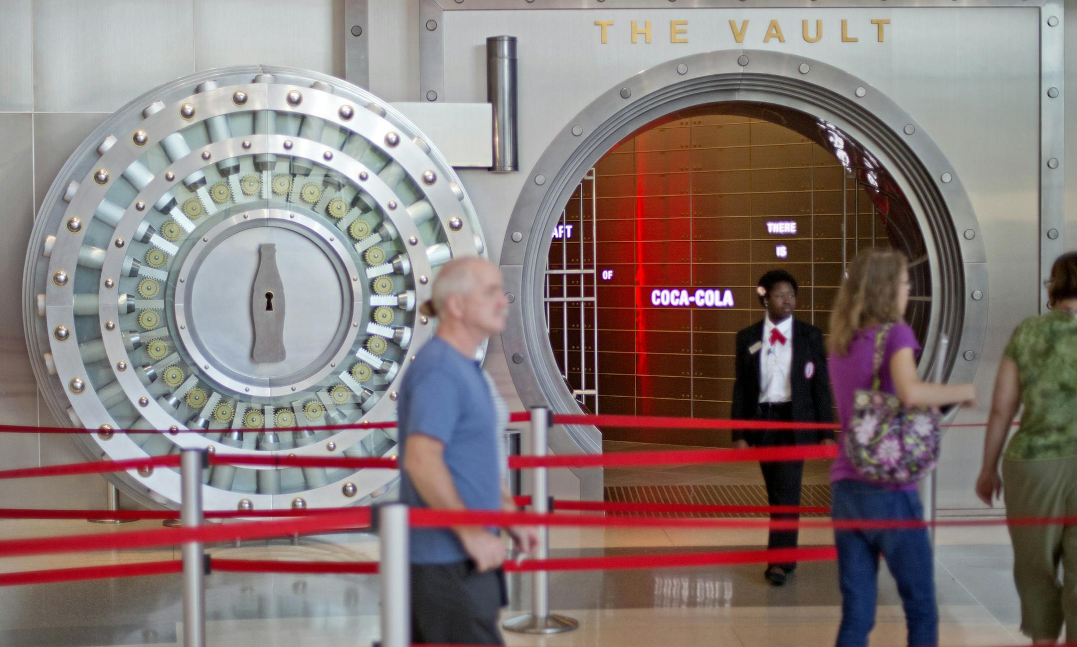 In this Friday, Aug. 9, 2013 photo, a tour group enters the vault exhibit containing the ìsecret recipeî for Coca-Cola at the World of Coca-Cola museum, in Atlanta. The 127-year-old recipe for Coke sits inside an imposing steel vault thatís bathed in red security lights, while security cameras monitor the area to make sure the fizzy formula stays a secret. (AP Photo/David Goldman)