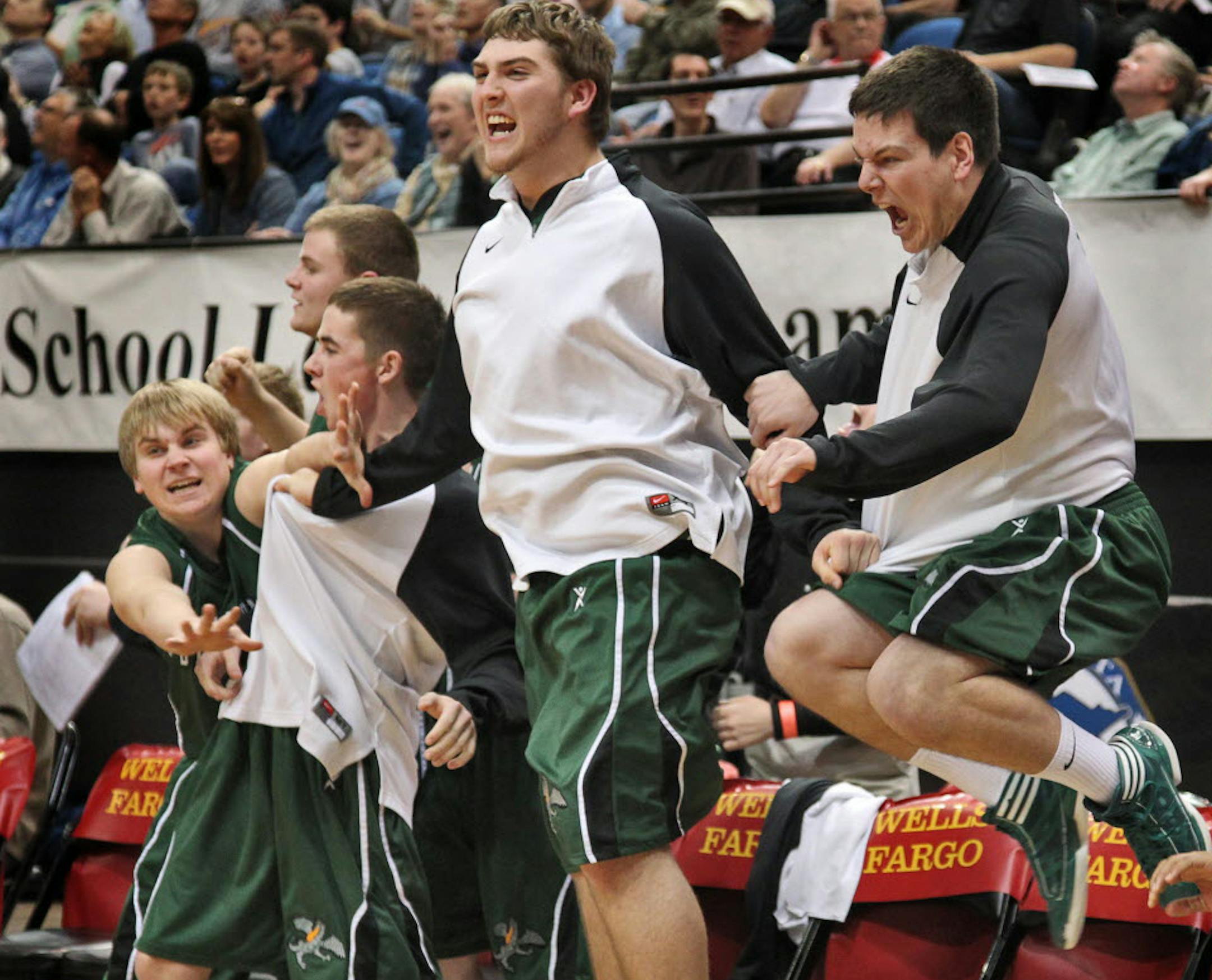 Litchfield players celebrated as teammate Zach Kinney made his last second shot to win the game and earn a spot in the Class 2A boys' basketball final.